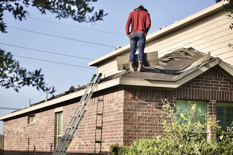 Professional roofer working on a residential roof in Coral Hills